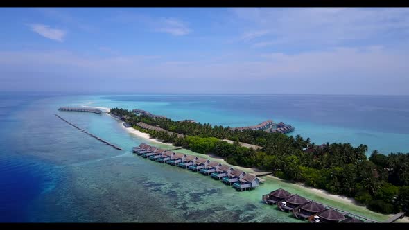 Aerial top down abstract of luxury resort beach wildlife by blue green sea and white sand background