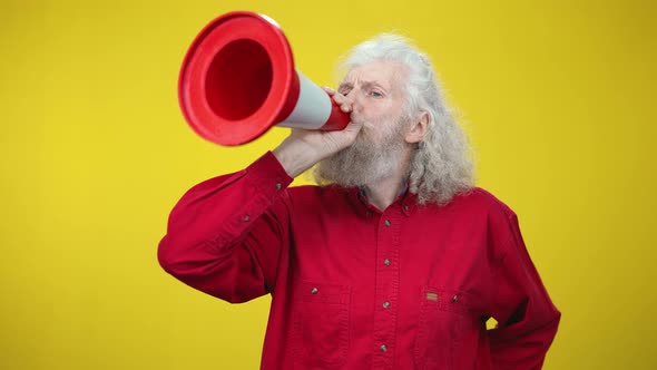 Cheerful Senior Greyhaired Man Imitating Speaking in Megaphone Using Road Cone