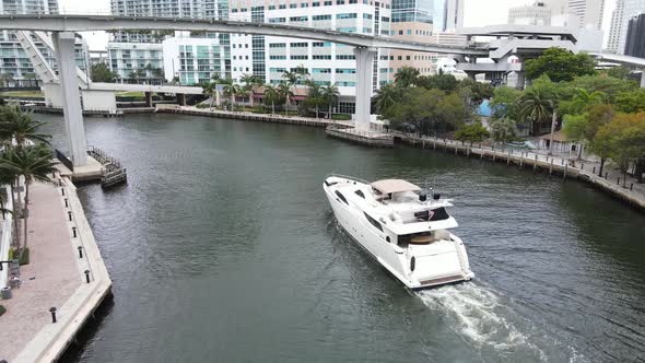 Luxury megayacht navigates its way back to its harbor on the Miami River in downtown Miami, Florida