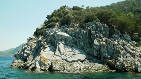 Stone strata on a green hill by the sea