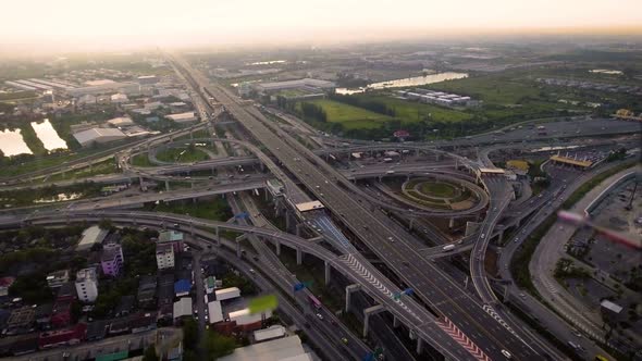 Aerial View of Highway Road Interchange with Busy Urban Traffic Speeding on Road