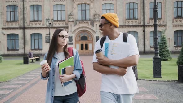 Two International Stylish Students Walk Near the Campus and Smile