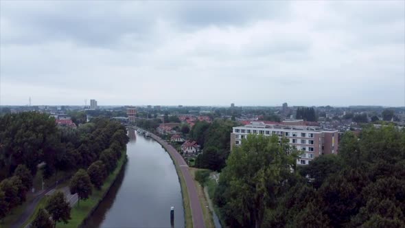 Aerial shot of elderly home along river flowing through suburbs of Leiden, the Netherlands