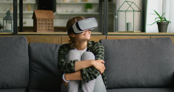 Young Woman Uses Virtual Reality Headset at Home