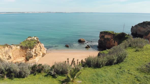 Pristine turquoise ocean shore bathing golden coast in Lagos Algarve, Portugal - Wide Panoramic shot