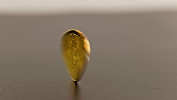 Bitcoin Coin Spinning on Gray Background  Closeup with Slowmo