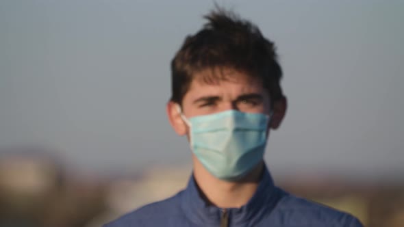 The Guy in the Medical Mask Fits Close To the Camera Slow Motion