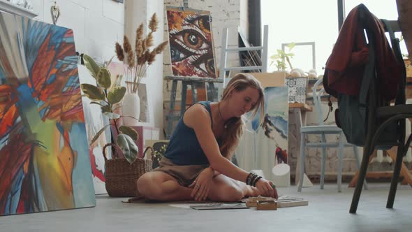 Female Artist Drawing with Crayons in Studio