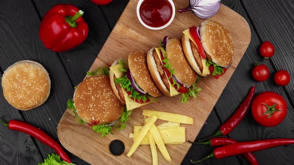 Vegetarian Burgers on a Wooden Board with Different Vegetables Ketchup and Cheese