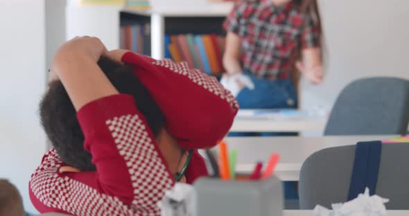 Afroamerican Boy Suffering Bullying in Classroom From Classmates