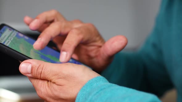 Man Searching on Smartphone Looking on a Map