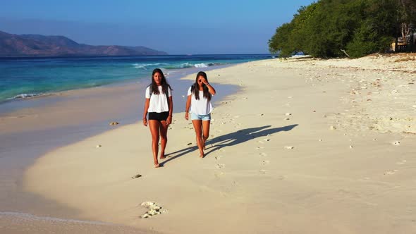 Ladies together look beautiful on marine seashore beach journey by blue lagoon with white sand backg