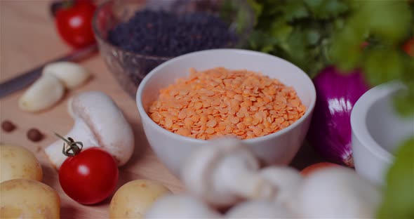 Fresh Food Ingredients On Wooden Table In Kitchen