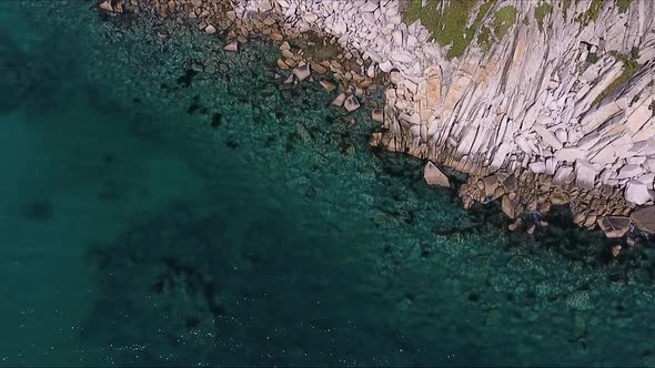 Aerial Shot of Mountain Cliff and Blue Sea Water
