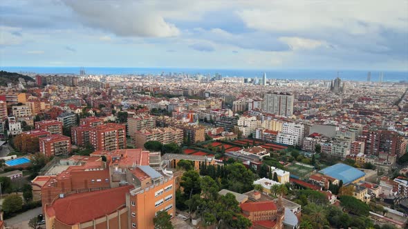 Aerial drone view of Barcelona, Spain. Multiple residential and office buildings, Mediterranean sea 