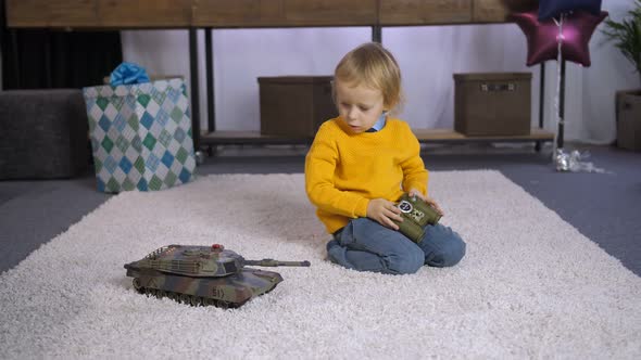 Serious Boy Learning To Play Remote Control Toy