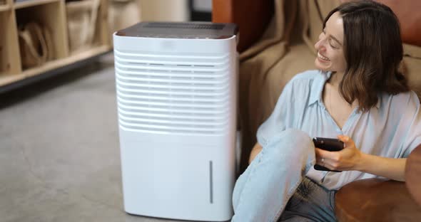 Woman with Air Purifier or Conditioner at Home