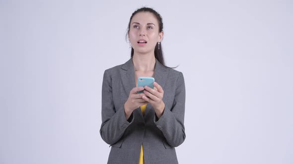 Happy Young Beautiful Businesswoman Thinking While Using Phone