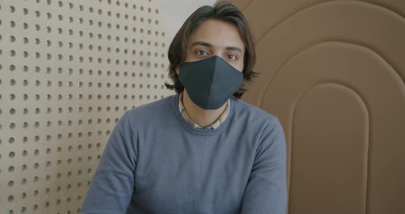 Portrait of Goodlooking Arab Guy Wearing Protective Face Mask Indoors