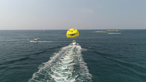 Drone view of parasailing activity in blue Adriatic sea in Istria, Croatia