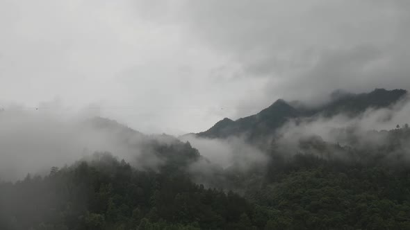 Time-lapse of moving clouds over Chinese Mountains.