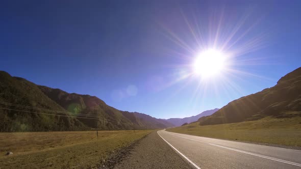 Mountain Road Timelapse at the Summer or Autumn Sunset Sunrise Time. Wild Nature and Rural Field.