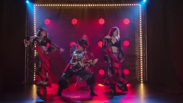 Three Charming Girls and a Guy Are Dancing in Gypsy Costumes. Theatrical Performance of Folk Dances