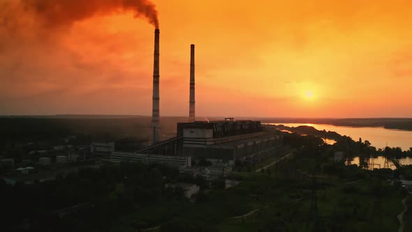 Aerial view of chimneys of factory during sunset