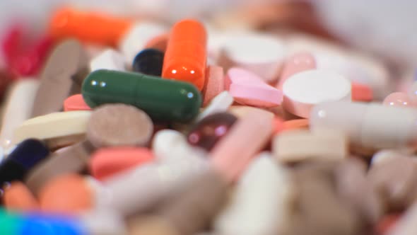 Many colorful pills rotate in close-up. macro photography. The concept of pharmacology and health.