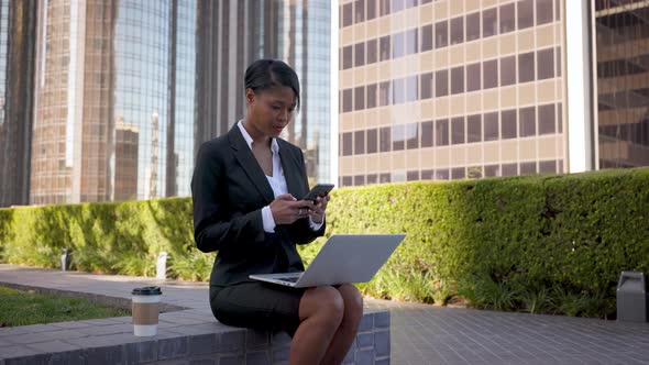 Mixed ethnicity business woman works on her laptop