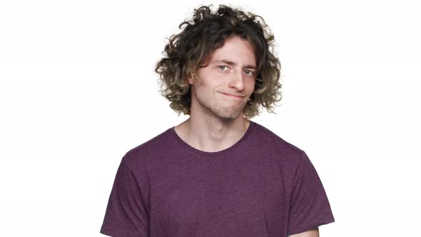 Portrait of Confused Upset Guy with Curly Hair in Casual Tshirt Shaking Head and Rejecting Proposal