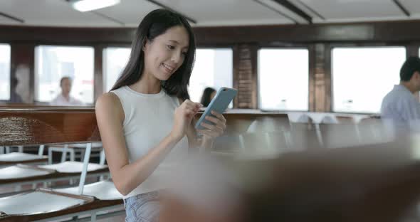 Woman using city map inside ferry 