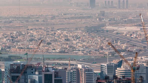 Aerial View of Business Bay Area with a Construction Site and Traffic on Highway Timelapse in Dubai