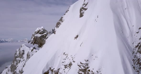 Aerial drone view of a scenic snowy mountain landscape.