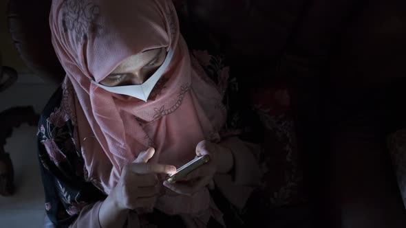 Women with Face Mask Hand Holding Smart Phone at Night