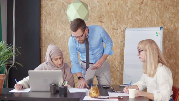 Man Consulting with a Woman in Office.