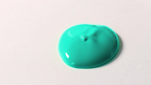 Big Cyan Blob Falls Onto White Surface