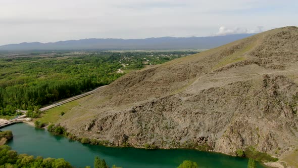 Aerial view of mountain river with the dam