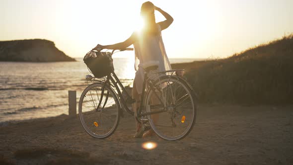 Wide Shot Relaxed Young Woman with Bike Admiring Beauty of Mediterranean Sea Standing on Beach at