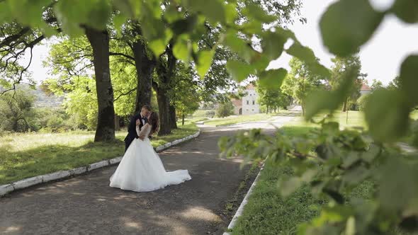 Caucasian Groom with Bride in the Park. Wedding Couple. Happy Family. Newlyweds