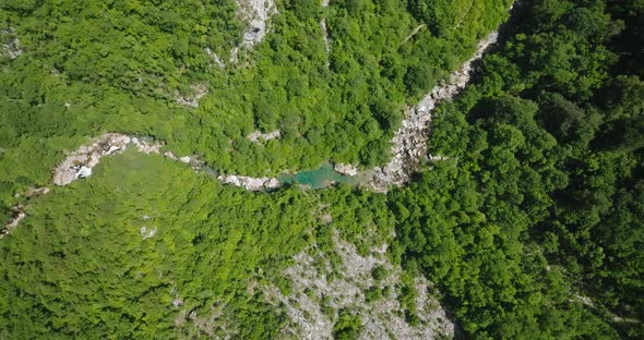 flying over a crystal clear blue water of mrtvica river in canyon