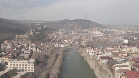 Aerial view of Metekhi church in old Tbilisi located on cliff near river Kura. Georgia 2021 winter