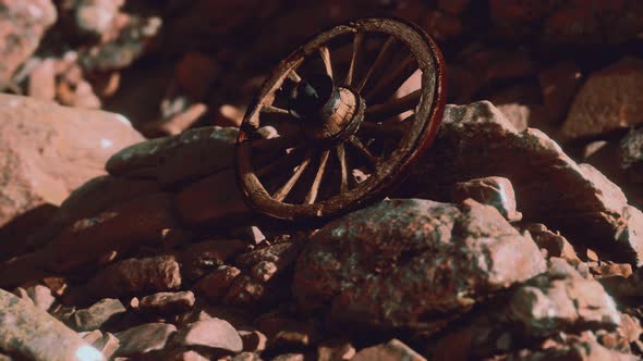 Old Wooden Wheel on Rocks