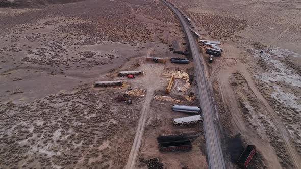 Rotating aerial view over train car wreckage after derailment in Utah