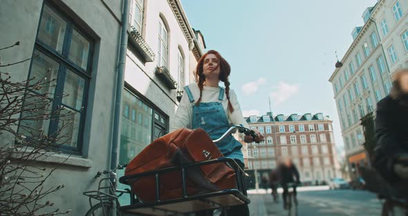 Attractive young woman standing with her bicycle