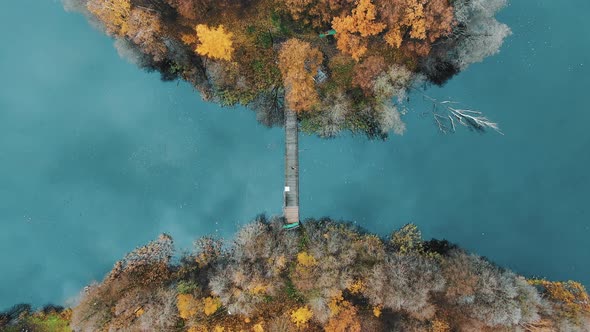 Fantastic Autumn Island on the Lake with a Bridge, Aerial View