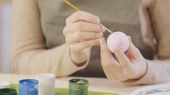 Hands of Woman Decorating Easter Egg