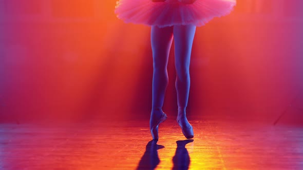 Ballet Dancer's Feet How She Practices in Pointe Shoes Exercises on Colorful Neon Spotlight