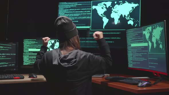 Back View Of Woman Hacker Using Computer Hacking And Celebrating, Code On Multiple Computer Screens
