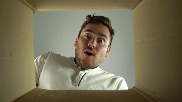 Bottom View Amazed Two Man Looks Into the Empty Box From the Inside